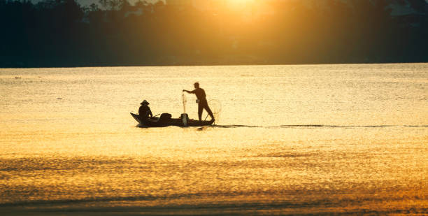 istock Fishing boats on river at sunset 1460807842