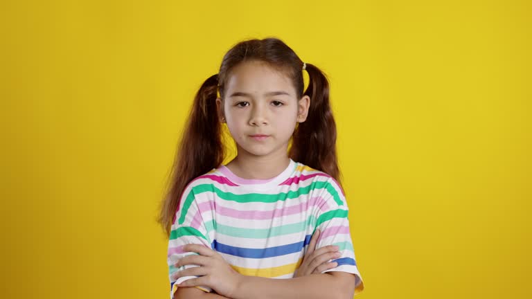 Cute girl is upset isolated yellow background.