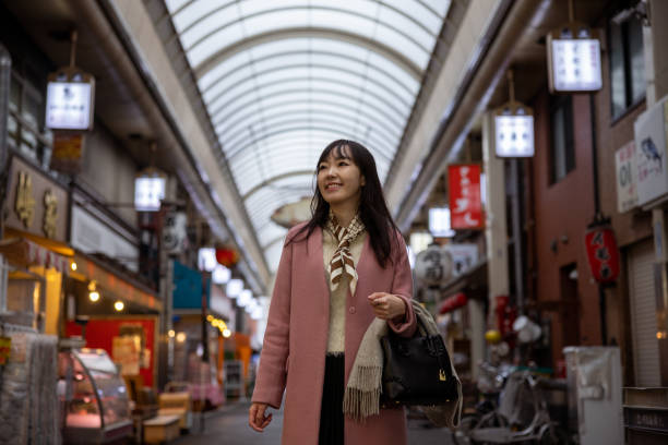 istock Young woman visiting shopping mall - low angle view 1460810241