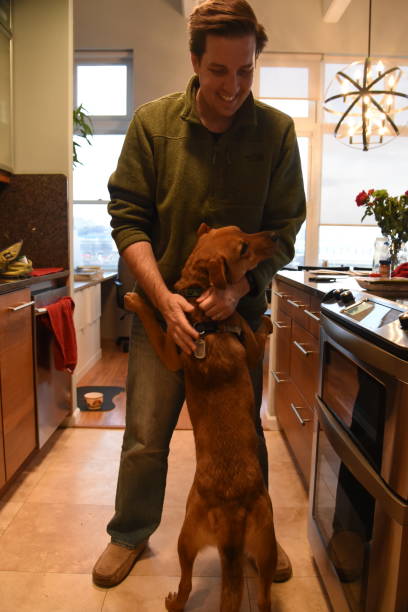 istock Man and dog embrace 1460811262