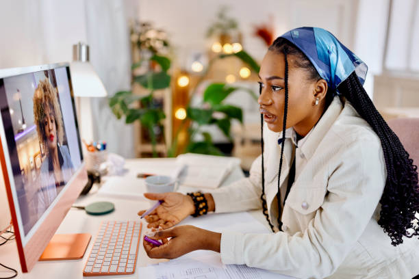 istock Online Education. Student uses computer to video call professor and learn at home 1460812236