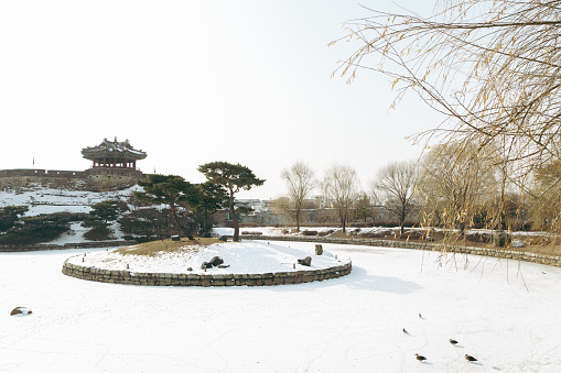 Winter of Hwaseong Fortress. Banghwasuryujeong Pavilion and Yongyeon pond with snow in Suwon, Korea
