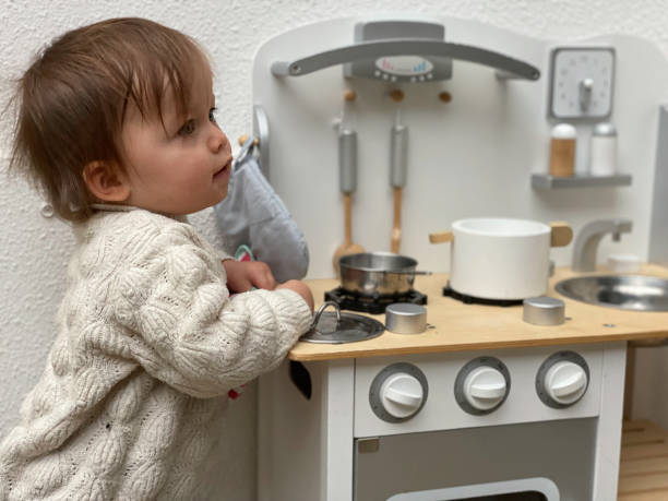 Cute Toddler girl playing with kitchen