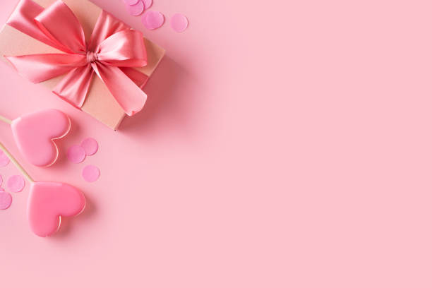 istock Candy pink lollipops with red gift box on pink background 1460817010