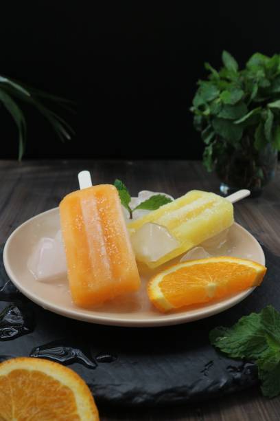 istock yellow and orange popsicles on a white plate 1460818079