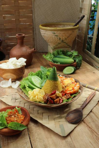 istock Indonesian traditional serving of Nasi Tumpeng on a rustic table 1460818982