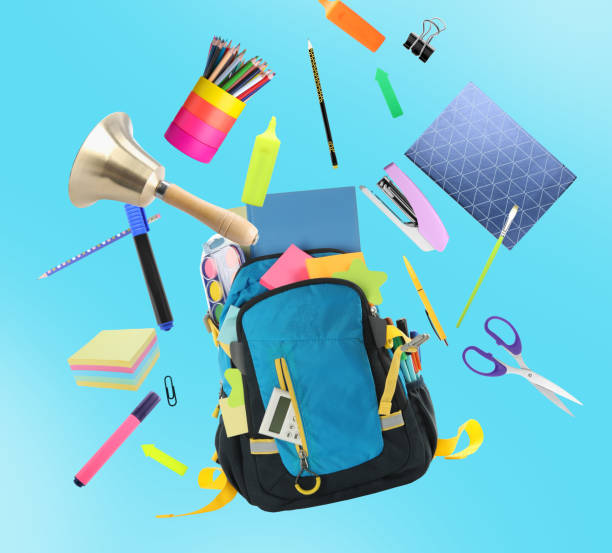 istock Backpack, school bell and different stationery flying on light blue background 1460820023
