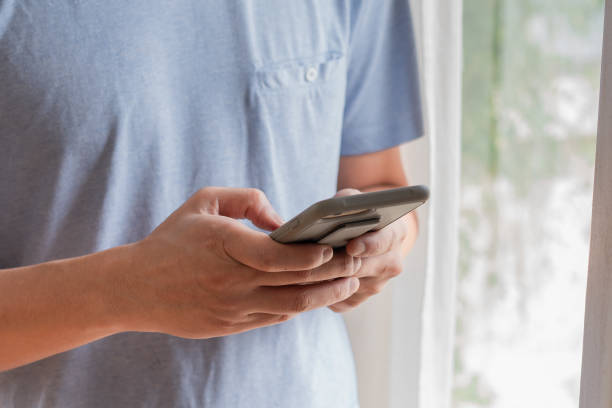 istock Close up hand of man using smartphone .Display mockup close up over shoulder view. 1460820291