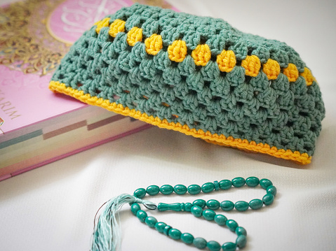 Prayer cap, beads and Quran