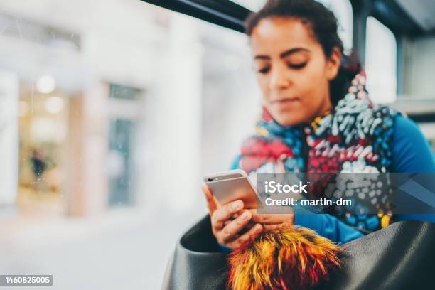 Mixed Race Woman In The Bus Typing On Smartphone Stock Photo - Download Image Now - Mode of Transport, One Person, People