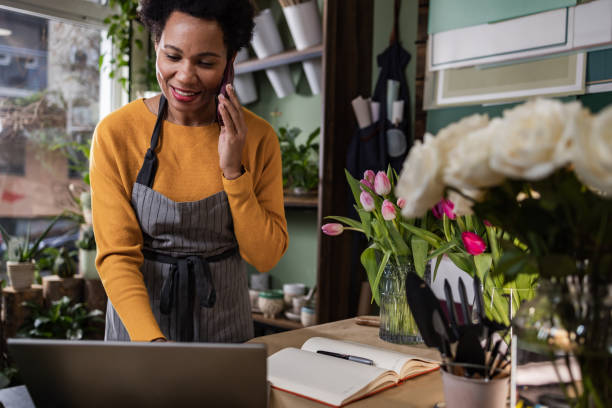 istock A smiling florist is receiving a customer order 1460829393