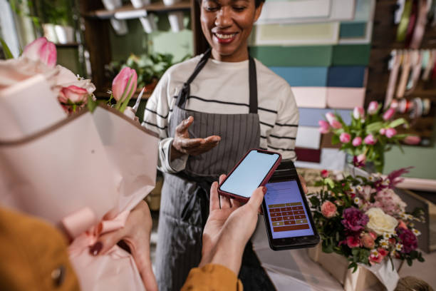 istock A customer is paying via NFC technology at the flower shop 1460829774