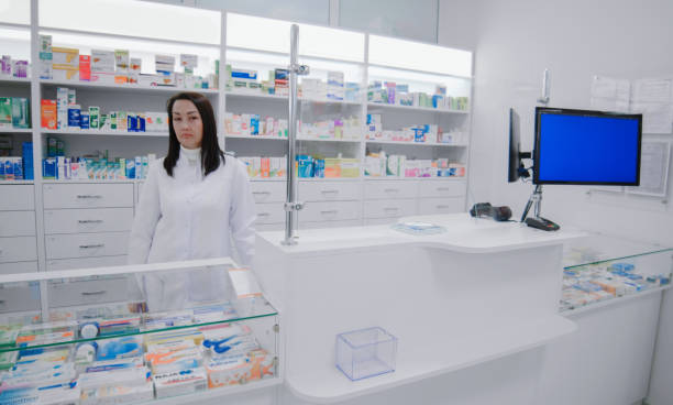 istock Pharmacist at the cash register during work at pharmacy 1460831049