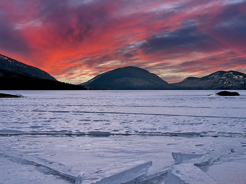 Red cotttage by frozen lake