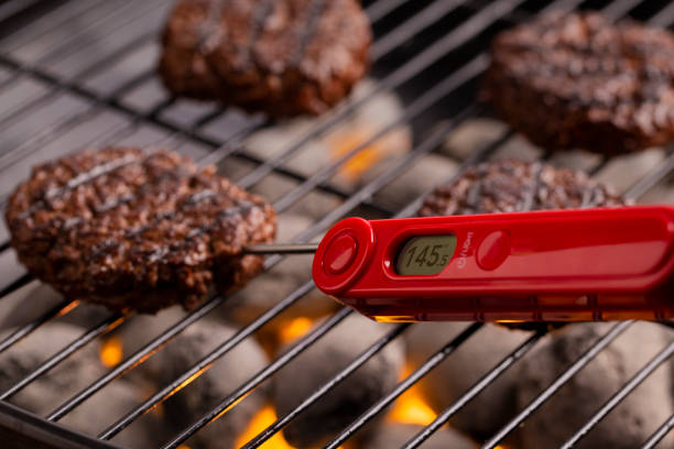 Smoke and a thermometer on a BBQ grill