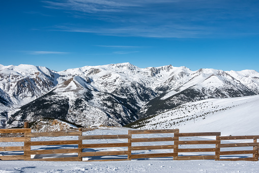 Mountain range of the Pyrenees with snowy mountains and blue sky in Andorra