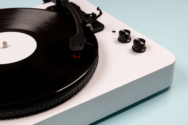 istock Vinyl turntable with vinyl plate on a blue background. Modern gramophone record player. Retro sound technology to play music 1460836551