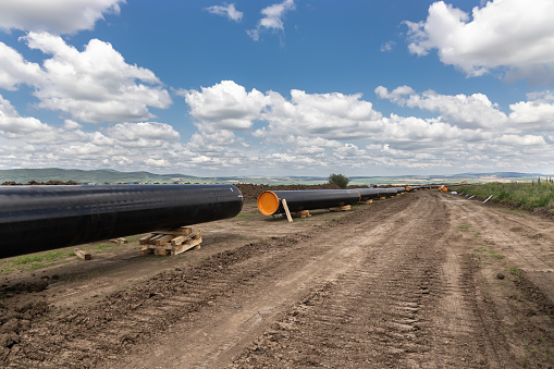 Gas and oil pipeline construction. Pipes welded together. Big pipeline is under construction.