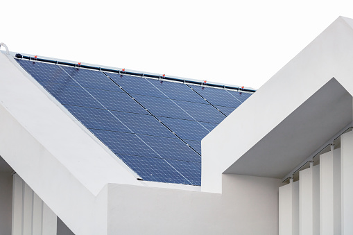 Close up of a roof covered with photovoltaic panels.