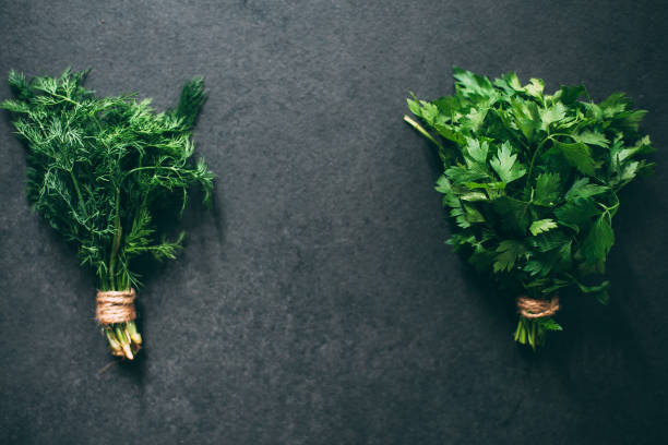 istock Dill and parsley on a dark granite table with a place for an inscription 1460837062