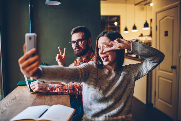 istock Cheerful freelancers taking selfie in restaurant 1460838887