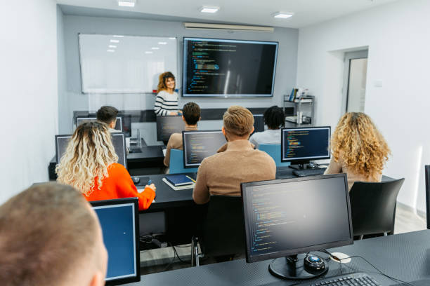 istock Mid Adult Female Teacher Teaching A Programing Class 1460840956