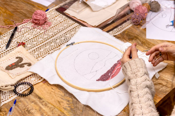 istock punch needle embroidery technique. Young woman working embroidery with hoop. 1460841355