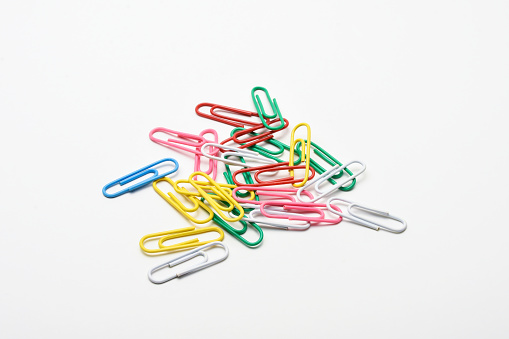 Colorful paperclips on the white background