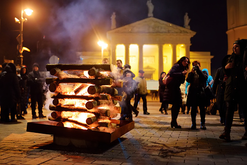 Vilnius, Lithuania - February 16, 2018: Hundreds of people attending the celebration of Restoration of the State Day in Vilnius. Bonfires are lit on Gediminas avenue on festive night on February 16.