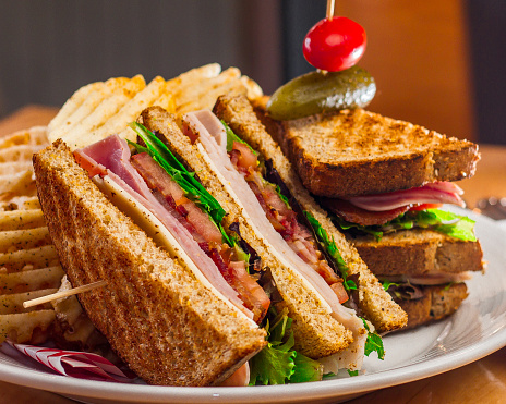Turkey club sandwich with a side of chips