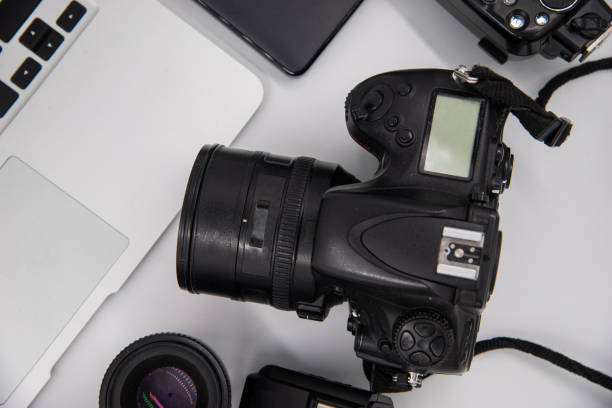 istock top view of work space photographer with digital camera, flash, cleaning kit, memory card, external hard disk, USB card reader, laptop and camera accessory on white table background 1460850223