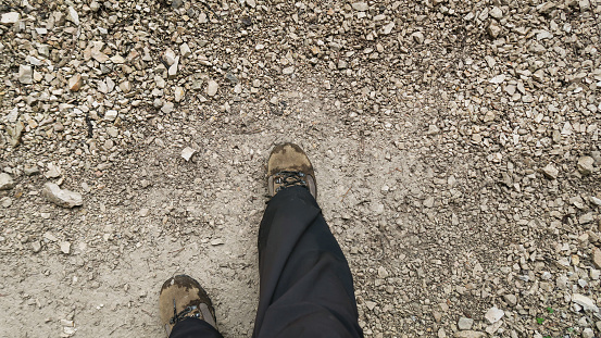 Dirty trekking shoes on the mountain trail