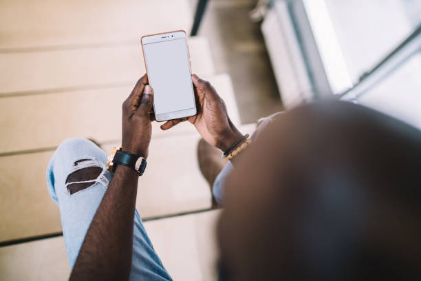 istock African American male using smartphone in room 1460853005