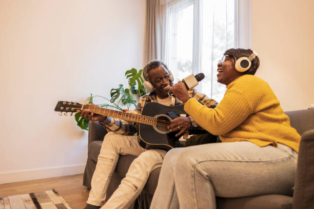 istock senior couple at home singing and playing guitar 1460853155