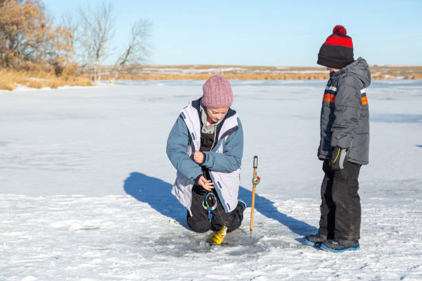 istock Girl Catching Perch While Ice Fishing with Brother 1460855207