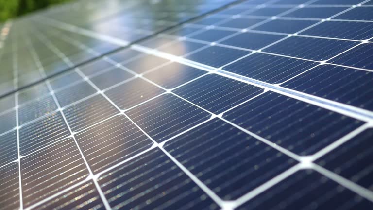 Close-up of modern photovoltaic solar battery. Rows of sustainable energy solar panels installed on farmland meadow rural field. Concept for ecology.