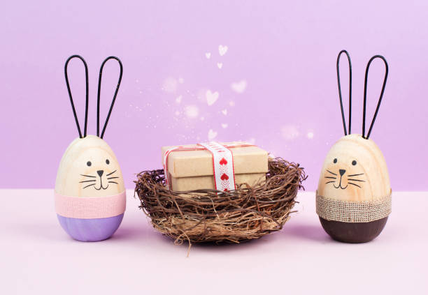 Wicker basket with gift and hearts, easter bunny or rabbit brings present, holiday greeting card