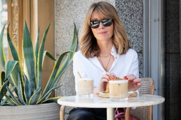 Attractive mature woman sitting outdoor coffee in the city stock photo