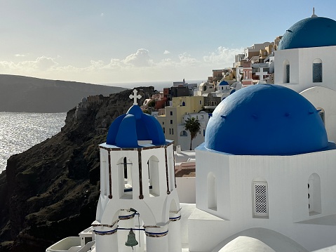 Famous Blue dome church architecture of Mykonos Greece with view of the ocean