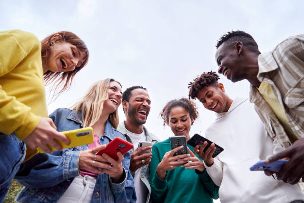 istock Multiracial Erasmus students, standing outdoors using their phones and laughing together. 1460864283