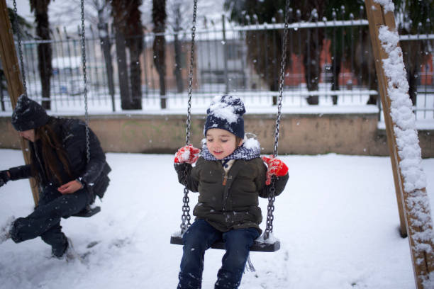 istock brothers swinging in the snow 1460865543