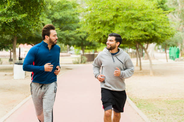 istock Fit men looking happy while running in the park 1460865802
