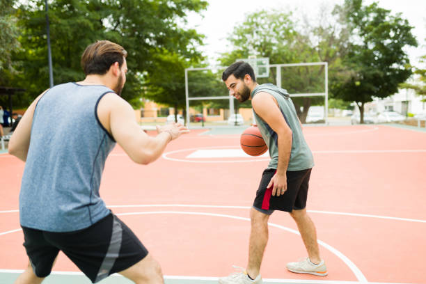 istock Happy friends having fun playing basketball 1460865921