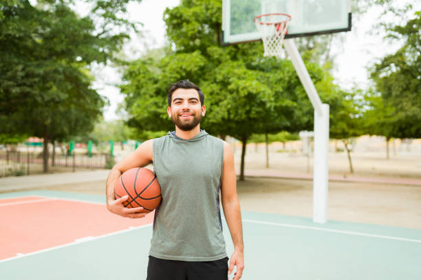 istock Attractive young man looking happy playing sports 1460866074