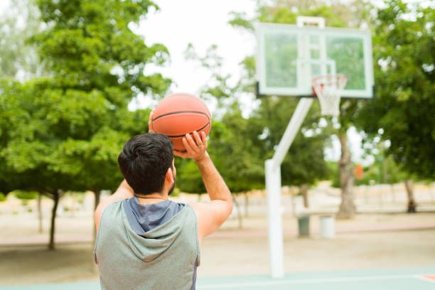 istock Rear view of a latin man practicing basketball 1460866141