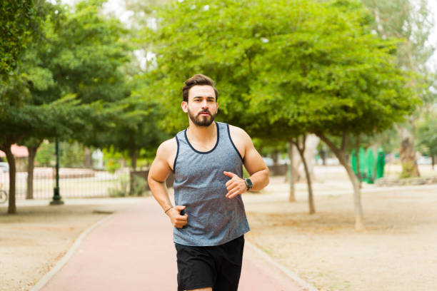 istock Active caucasian man starting jogging in the park 1460866283
