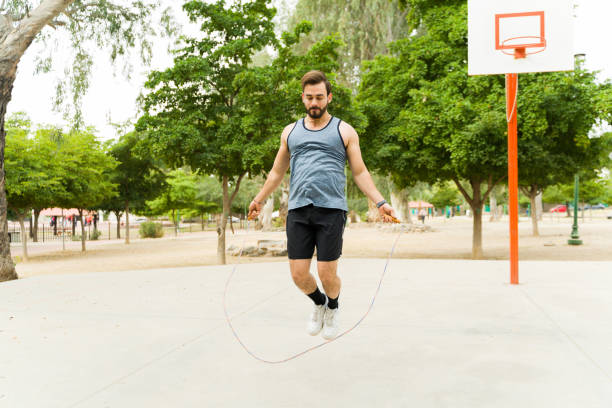 istock Young man jumping rope and working out 1460866435