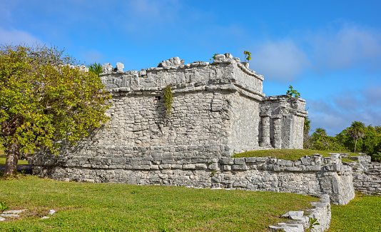 The dazzling Caribbean Sea is the backdrop for the ancient Mayan ruins at Tulum Mexico.