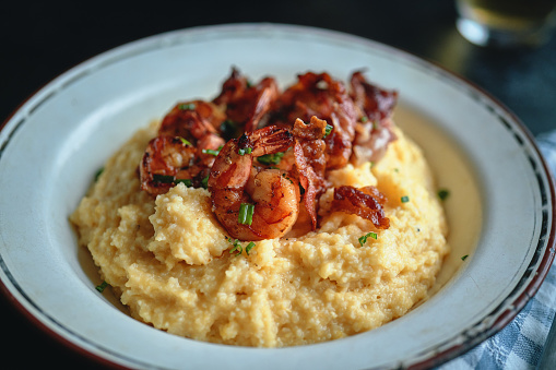 Shrimp, Crispy Bacon and Cramy Grits Served with Mixed Salad
