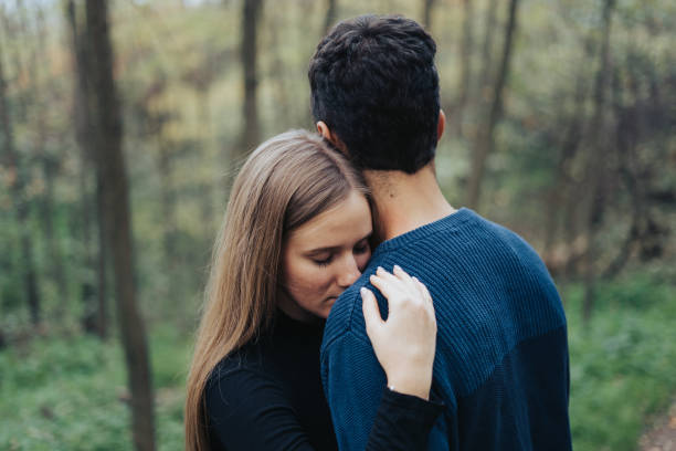 istock Young couple hugging in a forest 1460868856